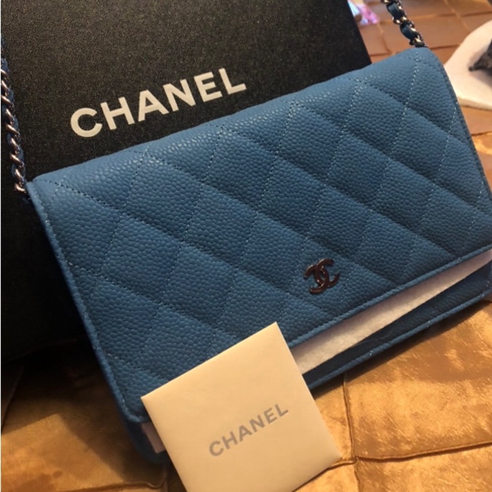 Luxury Teal Chanel clutch bag with shoulder strap.